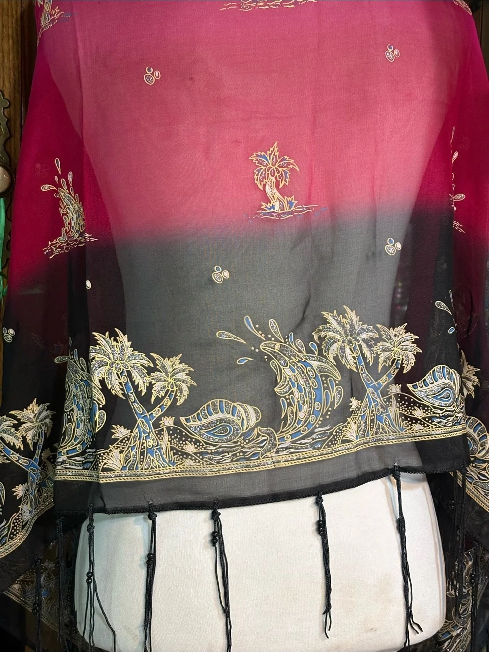 magenta and black scarf features palm tree motifs and black tassels along the ed